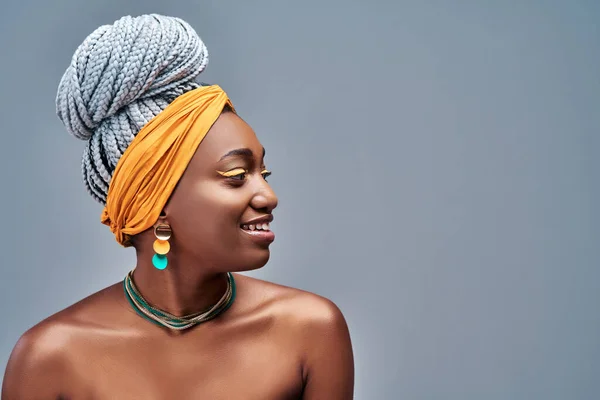 Close up view side portrait of cheerful young african woman smiling against gray background. Copy space