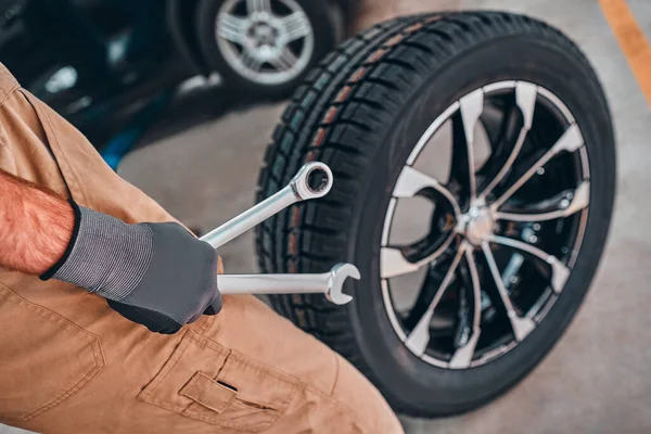 Vista Cerca Del Hombre Uniforme Trabajo Con Rueda Coche Interior —  Fotos de Stock