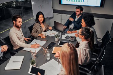 Business conference. A group of successful business people of different nationalities work together, discuss work. The concept of training, meeting, analysis, statistics.