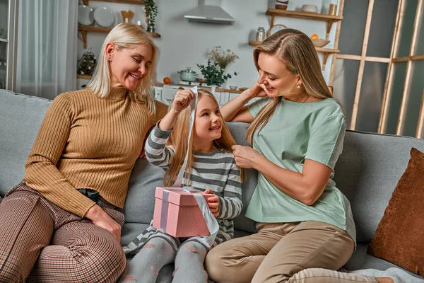 Little Daughter Unpacks Gift Mom Grandma — Stock Photo, Image