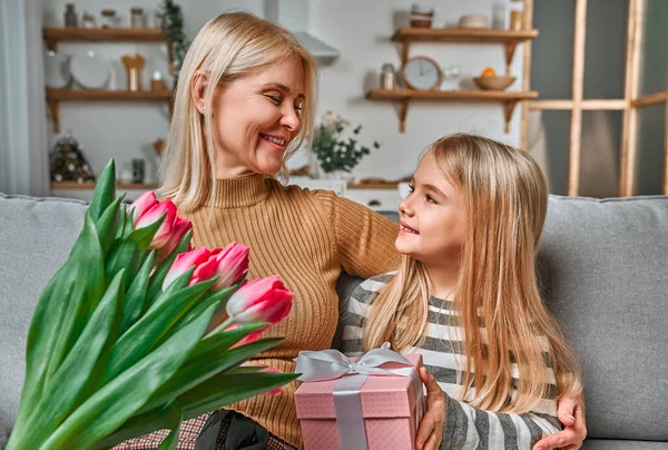 Grandma Gift You Little Beautiful Blonde Granddaughter Gives Her Grandmother — Stock Photo, Image