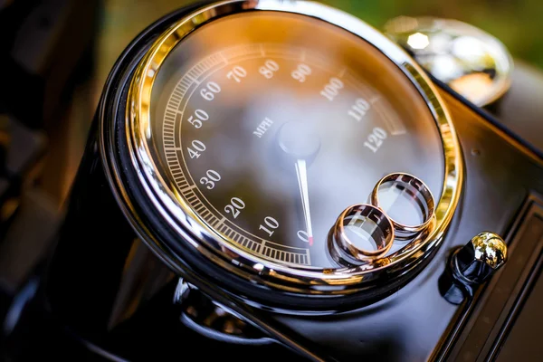 Wedding rings on a motorcycle speedometer — Stock Photo, Image