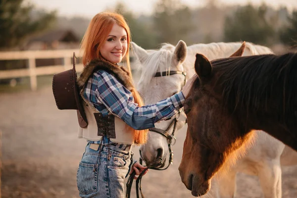 Woman stroking a horse at a ranch. — Stock Photo, Image