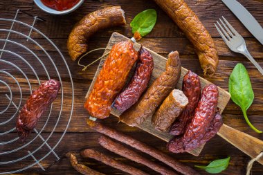 Eski ahşap bir masada çeşitli iştah açıcı et parçaları.