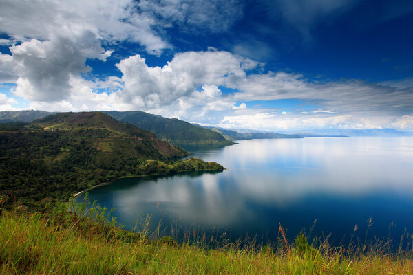beautiful reflection and blue sky on the lake Toba