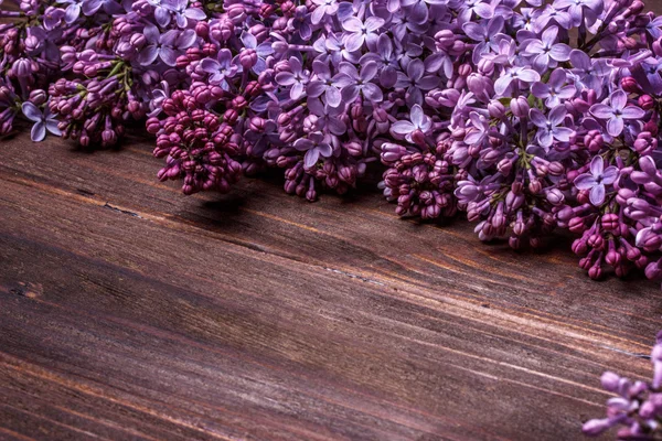 Lilac flowers on an  wooden board — Stock Photo, Image