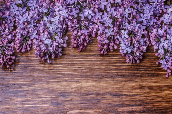 Lilac flowers on an  wooden board — Stock Photo, Image