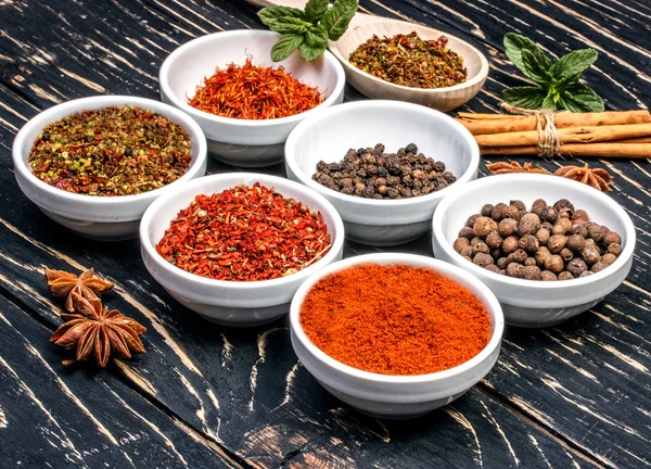 Colorful aromatic Indian spices and herbs on an old  oak wooden brown background — Stock Photo, Image