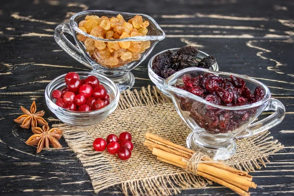Raisins in a bowl, cranberries, cinnamon and anise — Stock Photo, Image