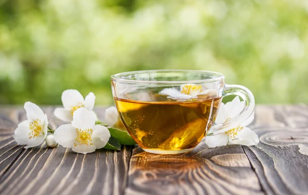 jasmine tea and jasmine flowers on  wooden background