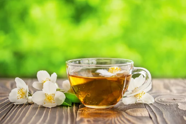 jasmine tea and jasmine flowers on  wooden background