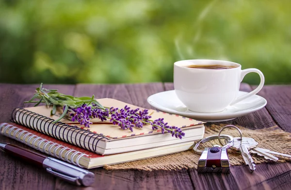 blank white notebook,the keys, bunch of lavender and cup of coffee