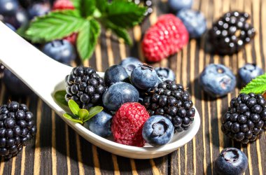 Ahududu, böğürtlen ve ahşap tahta üzerinde yaban mersini