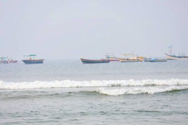 6 Aralık 2025, Panaji, Goa, Hindistan - Baga Sahili 'nin sularında süzülen yelkenliler Goan kıyı şeridi boyunca canlı bir tatil ortamı yaratıyor..