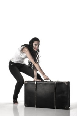 bir bavulla eğilmiş uzun kahverengi saçlı güzel kadın 