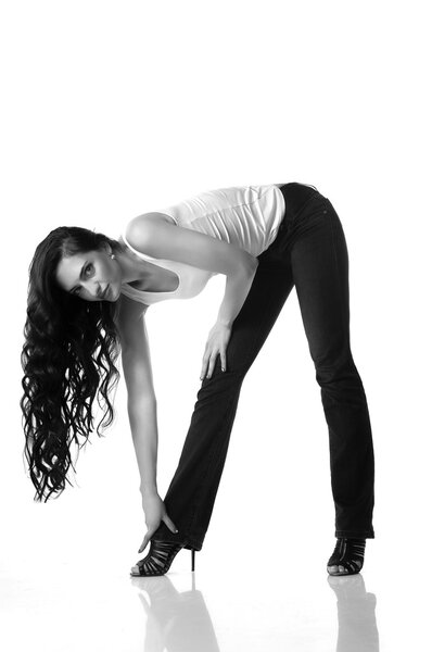 Beautiful woman with long brown hair bent over. Black and white photo
