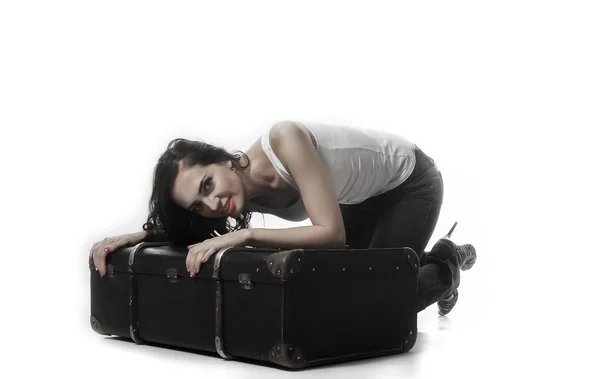 Beautiful woman. Beautiful woman with long brown hair bent over with a suitcase — Stock Photo, Image