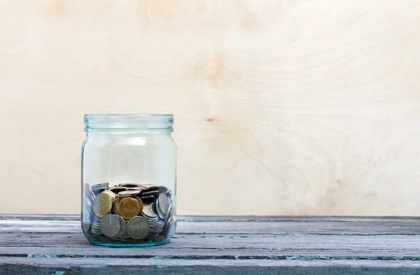 Coins in a glass jar — Stock Photo, Image