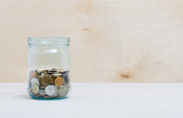 Coins in a glass jar — Stock Photo, Image