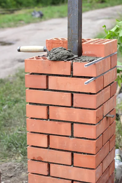 The new masonry fence under construction framework for Stock Image