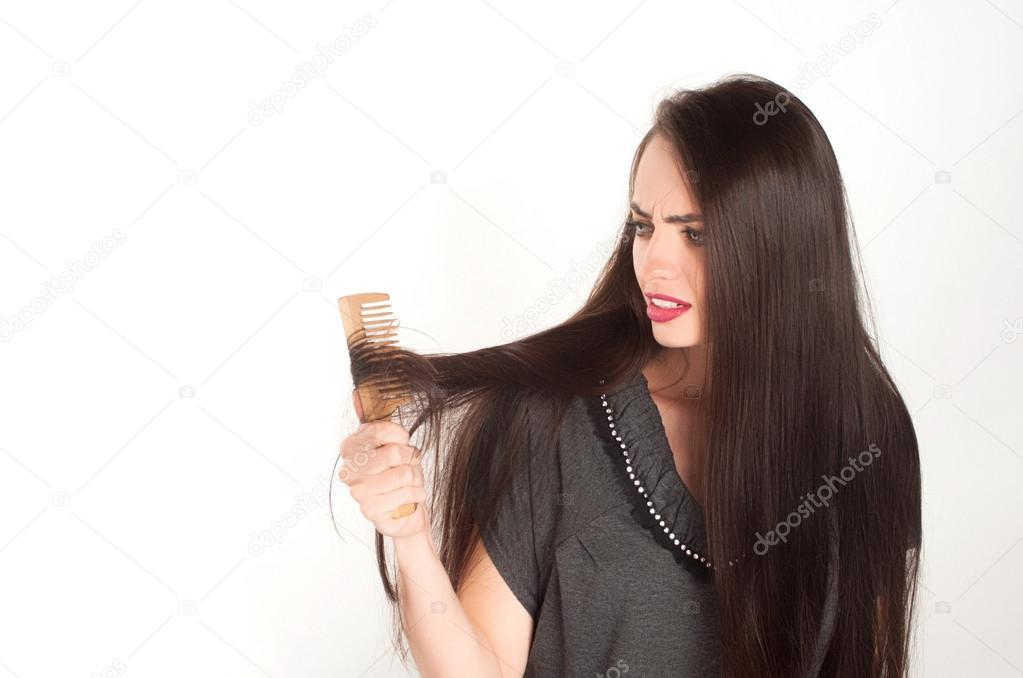 She combs her hair. She is terrified of hair loss