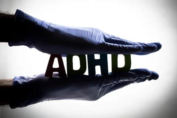 Word ADHD in outstretched hands — Stock Photo, Image