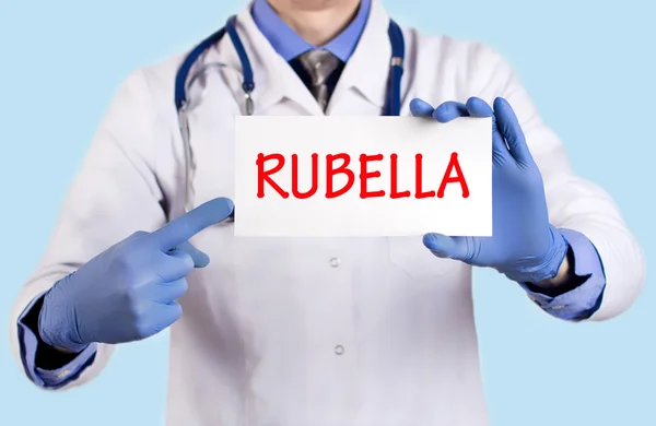 Doctor keeps a card with the name of the diagnosis - rubella — Stock Photo, Image