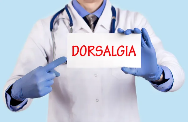 O doutor guarda um cartão com o nome do diagnóstico - dorsalgia — Fotografia de Stock