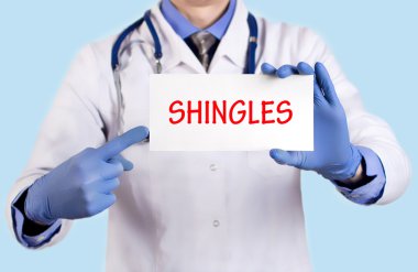 Doctor keeps a card with the name of the diagnosis - shingles clipart