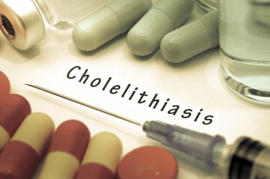 Cholelithiasis - diagnosis written on a white piece of paper. Syringe and vaccine with drugs. clipart
