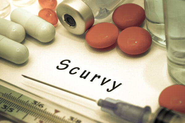 Scurvy - diagnosis written on a white piece of paper. Syringe and vaccine with drugs.