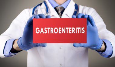 Doktorun mavi eldiven gösterilerinde kelime gastroenterit eller. Tıp kavramı.