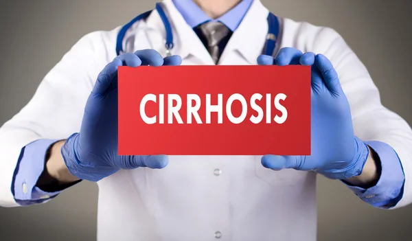 Doctor's hands in blue gloves shows the word cirrhosis. Medical concept. Stock Picture