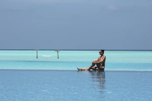 Hamac dans l'eau et fille aux Maldives et piscine à débordement — Photo