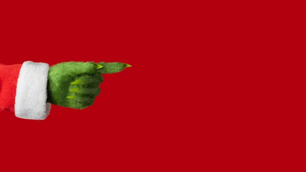 Noel Baba kıyafetli yeşil kıllı bir el kırmızı arka planda sağı işaret ediyor.