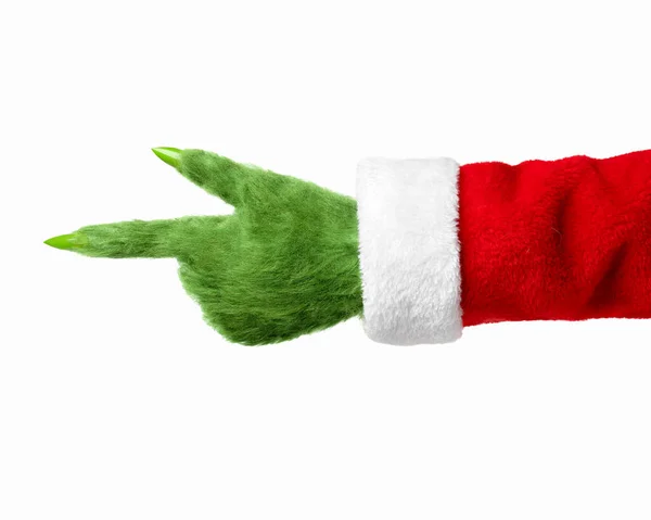 Een Groene Harige Hand Een Kerstmanpak Wijst Naar Links Geïsoleerd — Stockfoto