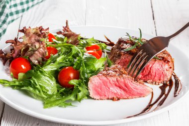 biftek ve bir pansteak kiraz domates ve domates bir tavada