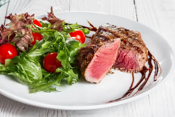 Bife e tomate cereja em um pansteak e tomate cereja em uma panela — Fotografia de Stock