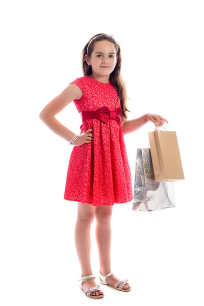 Ψώνια έννοια - χαριτωμένο κοριτσάκι με τις τσάντες που απομονώνονται σε λευκό φόντο — Φωτογραφία Αρχείου