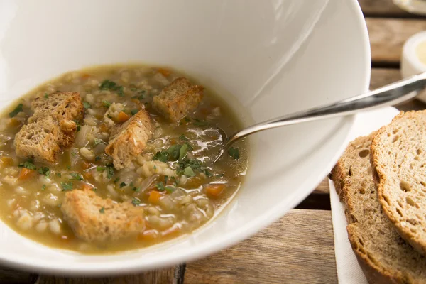 Pearl barley soup with ciabatta croutons — Stock Photo, Image