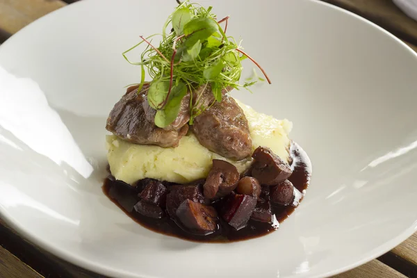 Braised pig cheeks, mash, pearl onions, pancetta & chestnut mushrooms