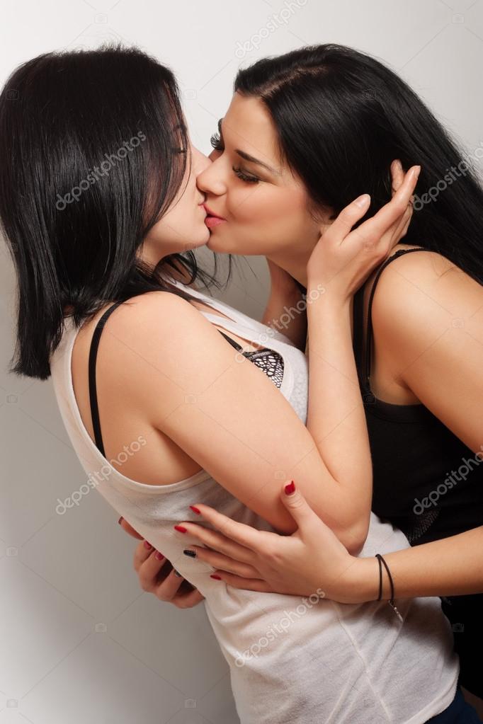 Portrait of two kissing lesbian women. 