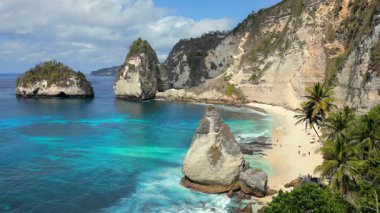 Kireçtaşı kayalıkları, turkuvaz okyanusu ve Endonezya, Bali 'deki Nusa Penida Adası' ndaki beyaz kumların ikonik elmas sahili..