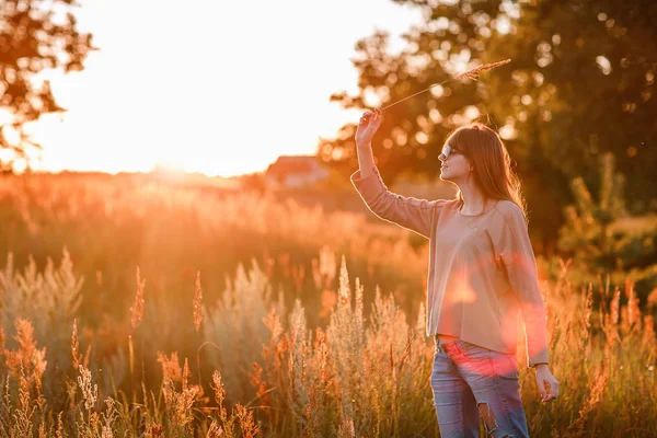 Jovem menina moderna no fundo por do sol . — Fotografia de Stock