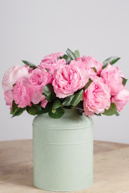 Çiçekçi zengin demet çiçek ışık arka plan, ahşap yüzey yaptım. Yeşil vazo