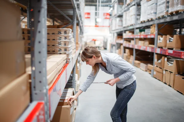 Sério pessoal mulher wrting no bloco de notas no supermercado — Fotografia de Stock