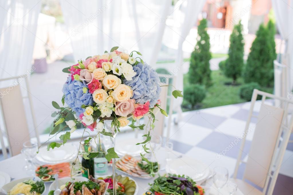 fresh floral composition on the holiday table. Beautifully organized event - served banquet tables ready for guests