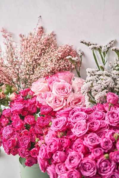 Set of white, pink and magenta flowers for Interior decorations. The work of the florist at a flower shop. Fresh cut flower.