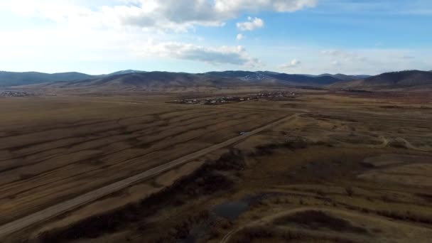 Aerial Flight over the road between fields. Autumn colors.Ulan-Ude — Stock Video