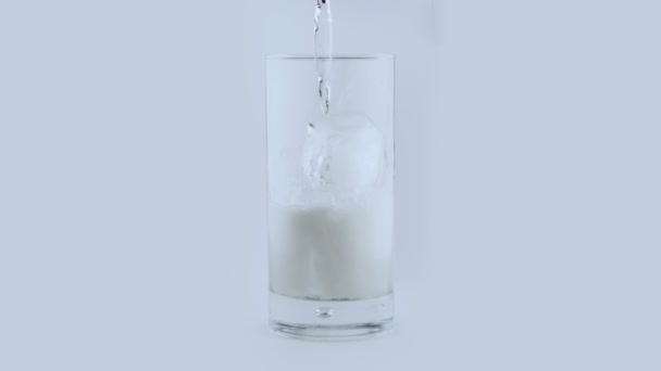Тонизирующая вода падает на стекло в замедленной съемке — стоковое видео